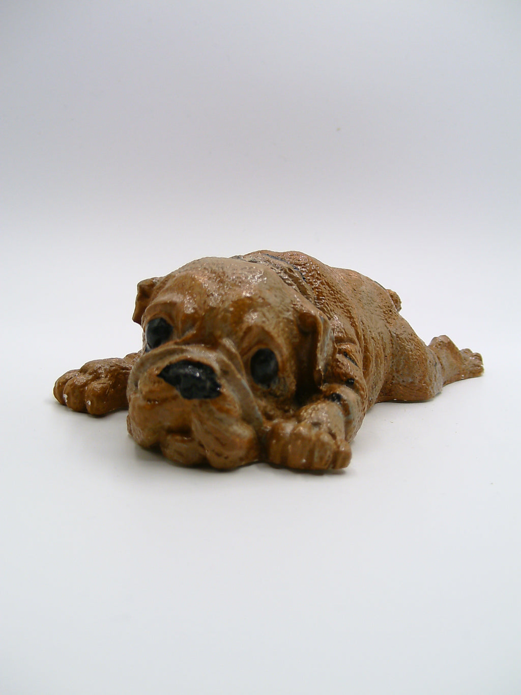 Bulldoggen-Figur aus Gips – liegend mit ausgestreckten Pfoten